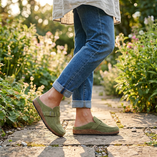 Woman wearing orthopaedic clogs on a garden path - lifestyle