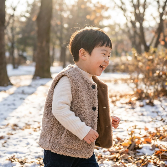 Child wearing a lamb wool waistcoat outdoors - lifestyle