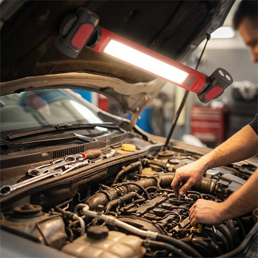 LED work light with magnetic base in a car engine bay - lifestyle